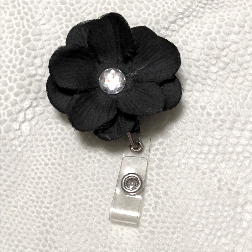 Black flower with rhinestone badge reel